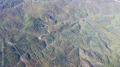 An aerial shot of a green hilly terrain 