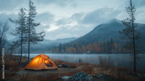 A cosy camp by a mountain lake at dawn. Suitable for articles about tourism, camping, outdoor recreation, and travelling to wild places.