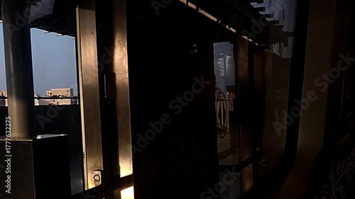 Ahmedabad cityscape seen from a moving metro train in bright daylight showing urban skyline, modern infrastructure, busy city life and dynamic travel perspective across the vibrant Gujarat landscape