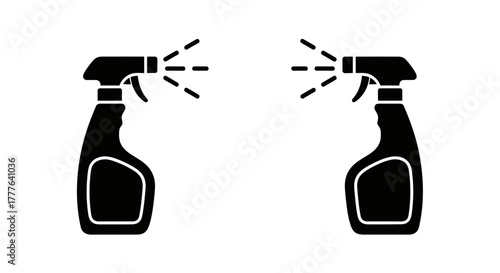 Two black spray bottles emitting a fine mist of liquid