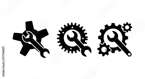 Black wrench and gear icons representing industrial maintenance and mechanical repair