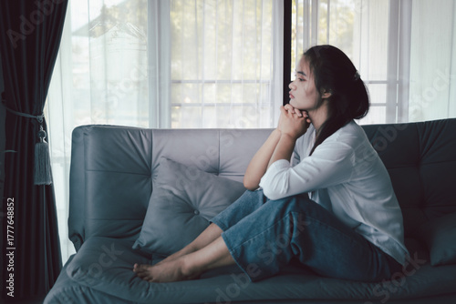 Photos Sorrowful woman sat alone, overwhelmed by emotion, her sad and unhappy expression revealing deep despair, stress and distress left feeling depressed