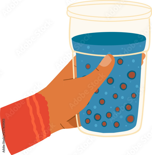 Hand holding glass of bubbly blue beverage