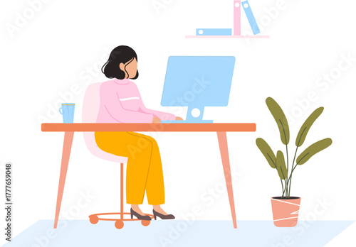 Woman working on desktop computer at home office desk