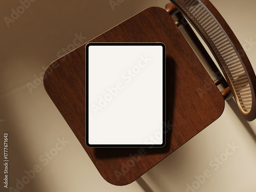 Tablet pad on wooden chair with soft light and clean background.