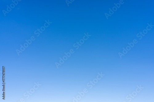 A clear and bright blue sky with no clouds visible