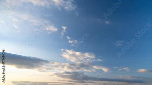 Fototapeta Naklejka Na Ścianę i Meble -  Blue sky with scattered white clouds under the sunlight