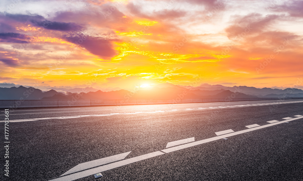 Fototapeta premium Empty asphalt highway road and mountain range with beautiful sky clouds at sunset