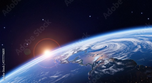 A vibrant sunrise over the Earth's horizon with a large, swirling cloud formation in the eastern hemisphere.