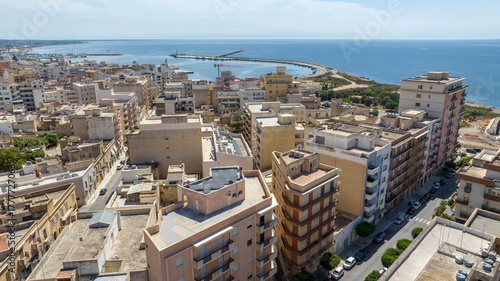 Fototapeta Naklejka Na Ścianę i Meble -  Aerial view of buildings on the outskirts of Marsala, in the province of Trapani, Sicily, Italy. In the background is the small tourist port.