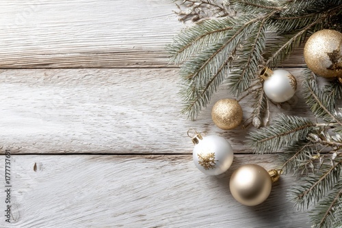 Elegant white and gold Christmas ornaments with pine branches on wooden background