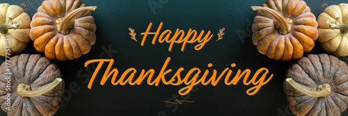 Thanksgiving greetings card. Thanksgiving day background pumpkins, autumn decorations on dark background. Happy Thanksgiving concept