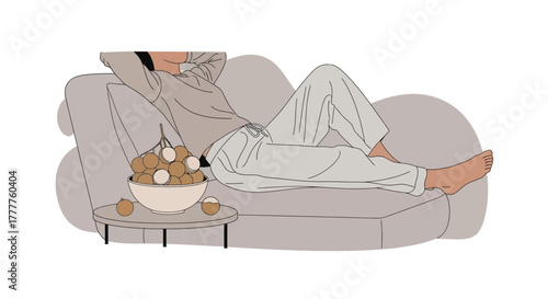 Person Relaxing on Couch with Bowl of Fruit in a Quiet Moment of Indulgence