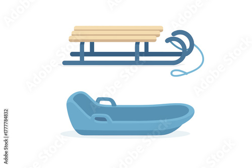 Classic wooden sled and modern blue plastic snow tube for winter recreation