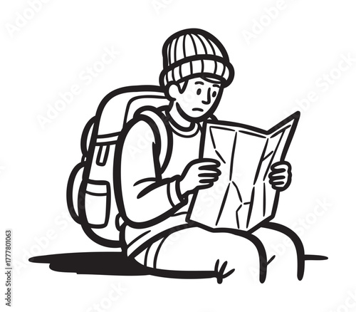 Young caucasian male hiker sitting and attentively reading a map while wearing a beanie and carrying a backpack.