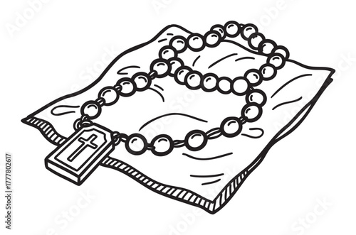 Black and white line art of a beaded rosary with a cross pendant lying on a pillow, evoking a sense of faith and spirituality.