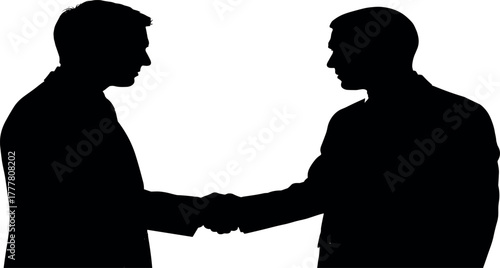 Silhouetted Businessmen Conclude Deal with Handshake.