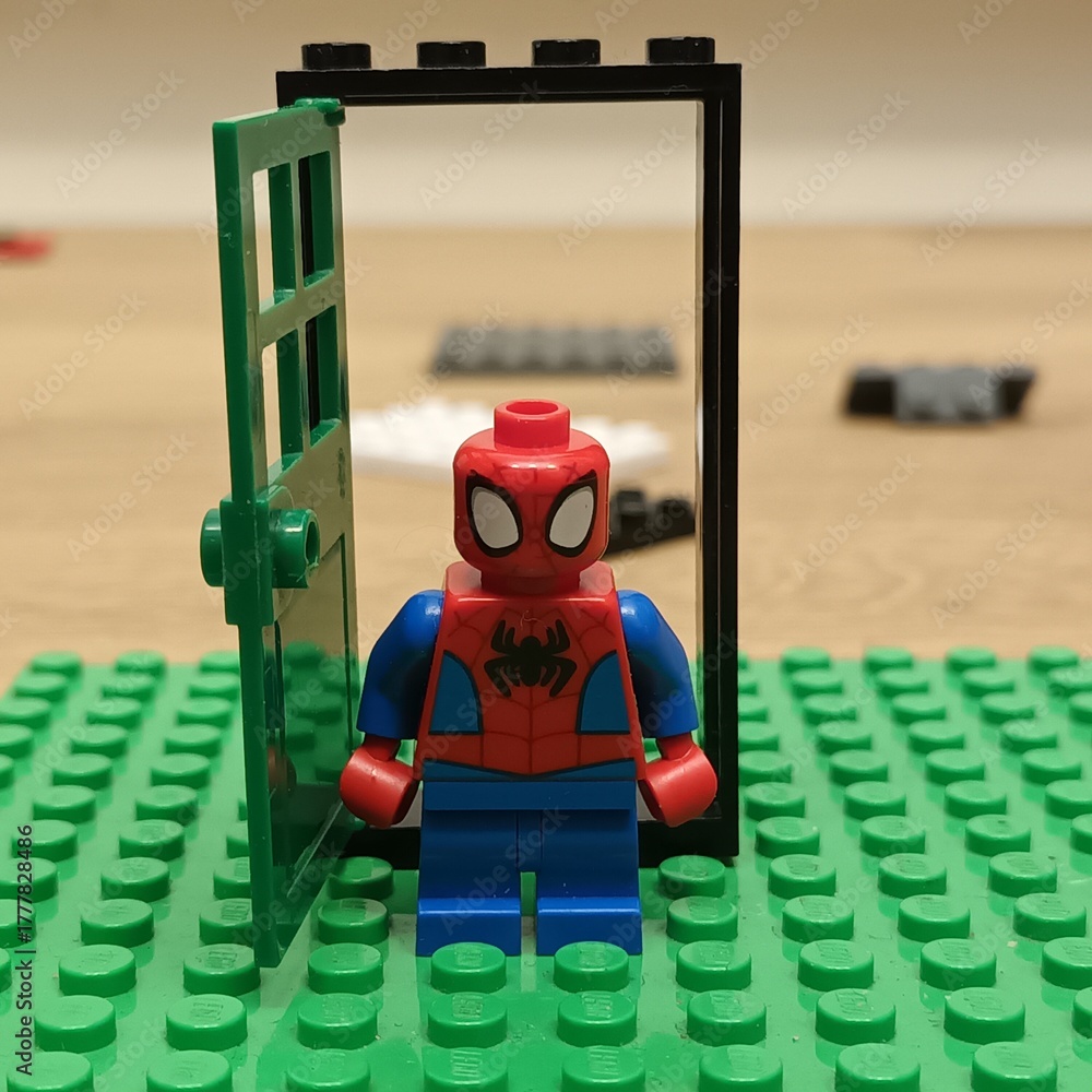 Naklejka premium Spider-Man Lego minifigure stands at an open doorway made of Lego bricks