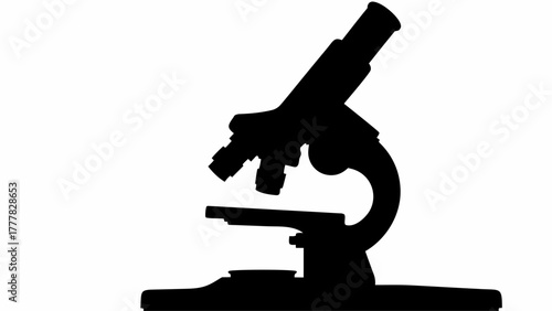 Silhouette of a microscope with a clear view of the lens and stage in a monochrome image style