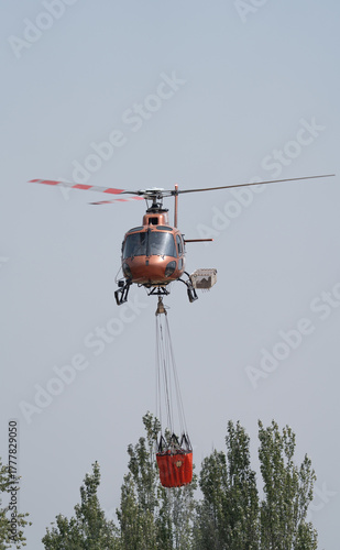 Obraz na płótnie Helicopter Performing Firefighting Water Drop Operation