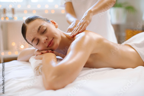 Tableau sur toile Relaxed lady with eyes closed in contentment lying during relaxing therapeutic b