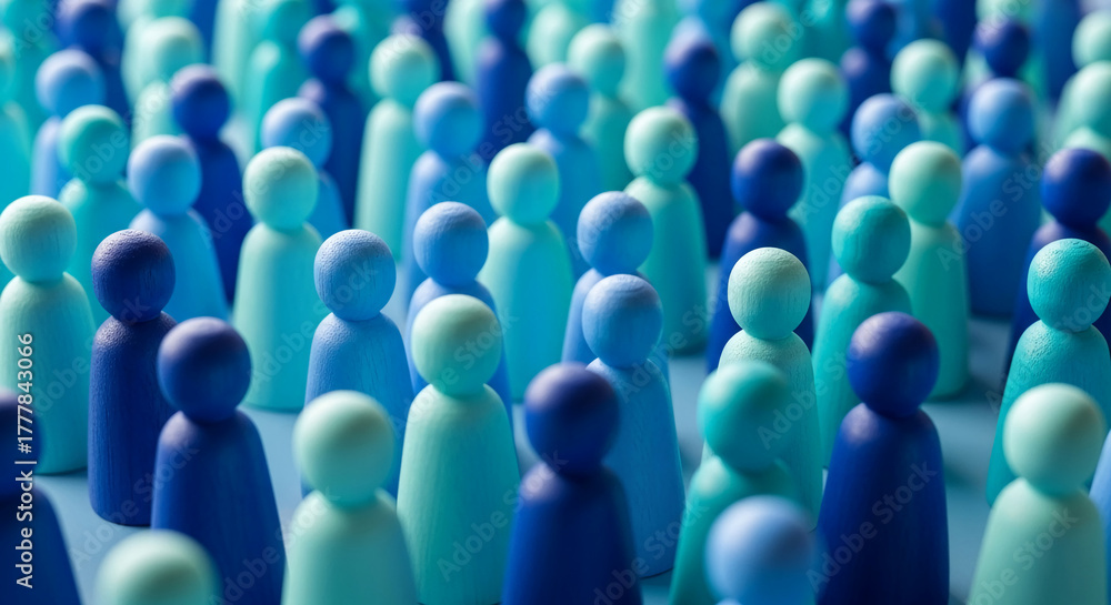 Fototapeta premium Many wooden figures in blue tones, arranged close together, represent a crowd, a community or population, ideal for social or demographic concepts