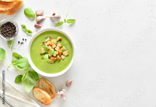 Spinach soup with croutons in white bowl