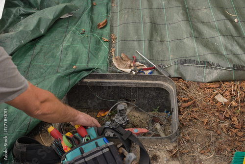 Photos Technician performing maintenance work on an irrigation valve