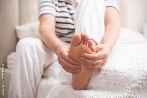 Young woman feeling pain in her foot