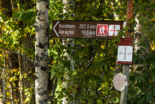 Wooden trail direction sign cross close-up St. Olavsleden pilgrimage route in Sweden
