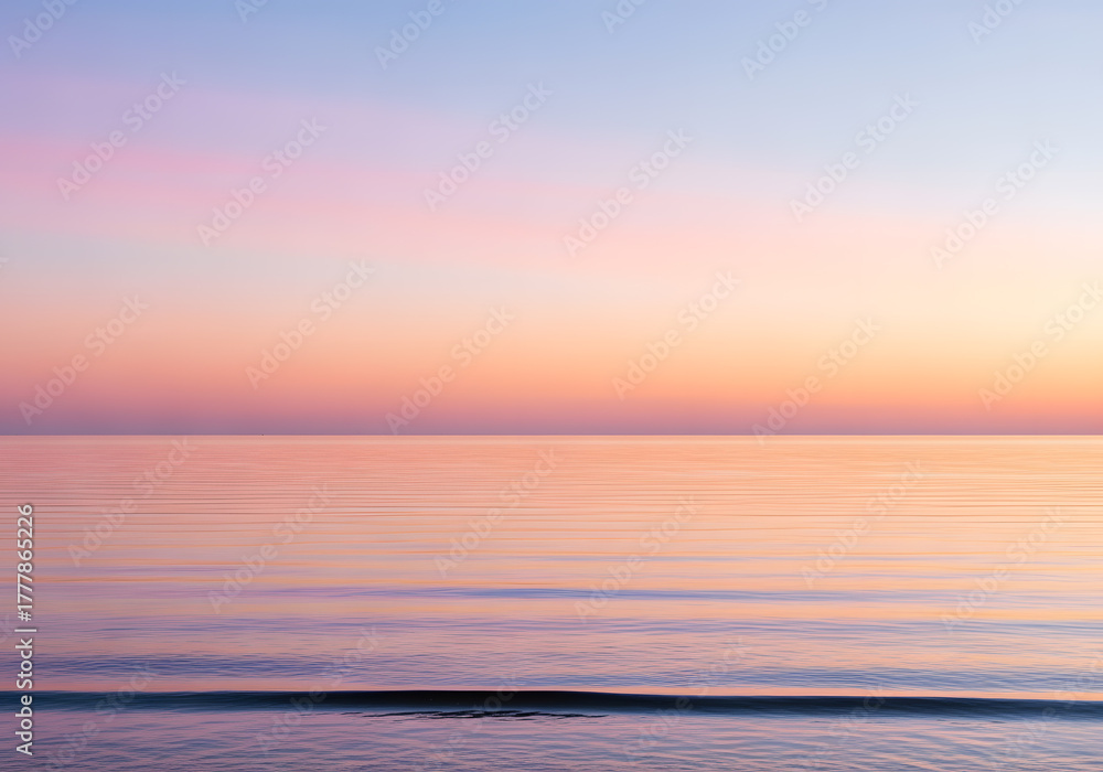 Fototapeta premium Pastel Sunset Sky Over Calm Ocean Water