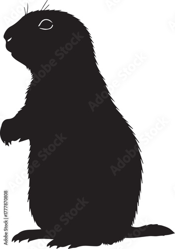 Silhouette of a prairie dog standing upright on its hind legs against a plain