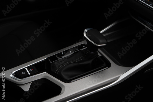 Car interior indoor. Black leather automatic gearbox with chrome button
