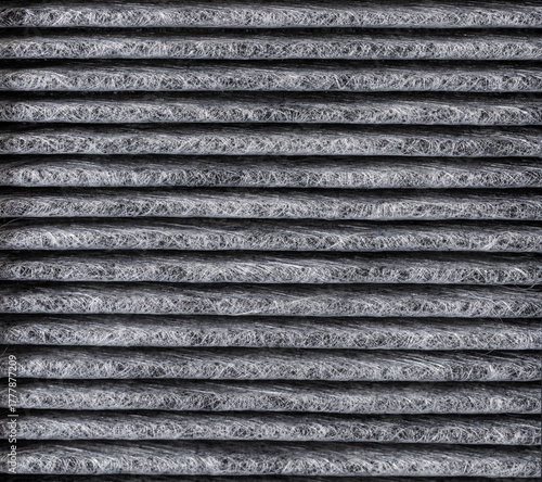 The replaced car air filter reveals a clear difference between the dirty, dust-covered air intake side and the cleaner air outlet side, showing how it traps impurities.