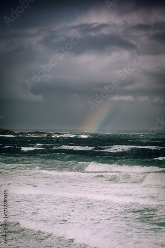 Dramatic Stormy Sea with Rainbow and Dark Skies