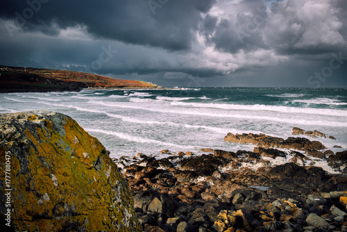 Sunlight and Storm Clouds over Rugged Cornwall Coastline