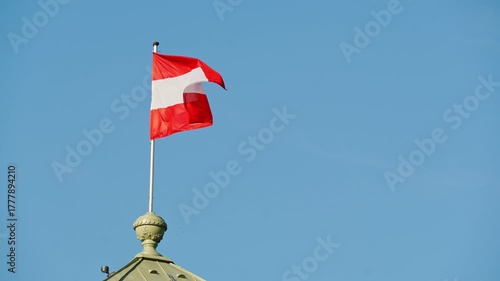 Waving National Flag of Austria against Blue Sky. Slow Motion