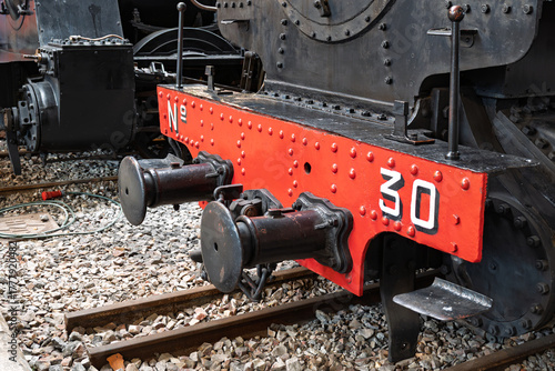 Spain – Detail of an old coal-powered locomotive on display, showcasing its vintage machinery and industrial heritage under natural daylight.