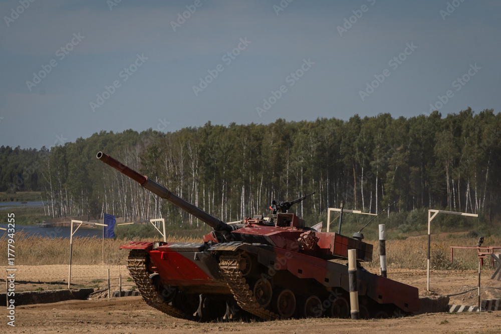Fototapeta premium Tank Maneuvering in Training Exercise on Rugged Terrain