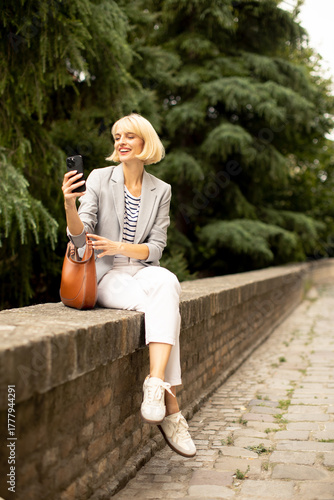 Smiling woman sitting on br...
