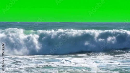 Powerful ocean waves crashing and breaking with white foam against a vibrant green screen background perfect for compositing and visual effects projects.