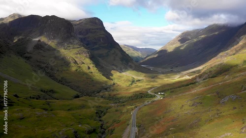 Scenic drone view of a road winding through highlands in Scotland near Glencoe