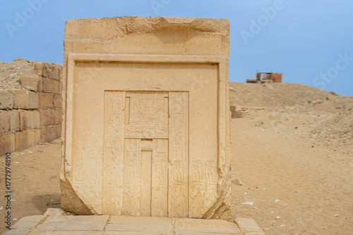 Photos Ancient limestone false door standing in the desert necropolis of Saqqara, Egypt