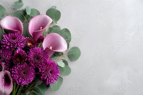 Vibrant Bouquet of Purple Flowers With Green Leaves on Grey Background