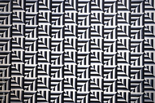 Optical illusion geometric pattern in black and white, repeating maze background