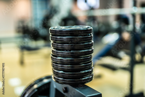 Gym weight stack closeup. Vertical stack of gym weight plates used for strength training.