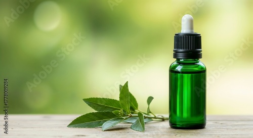 Natural cosmetic product concept with green glass bottle and fresh herbs