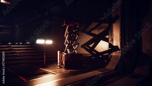 Photos Heavy machinery sits idle in a dimly lit industrial space