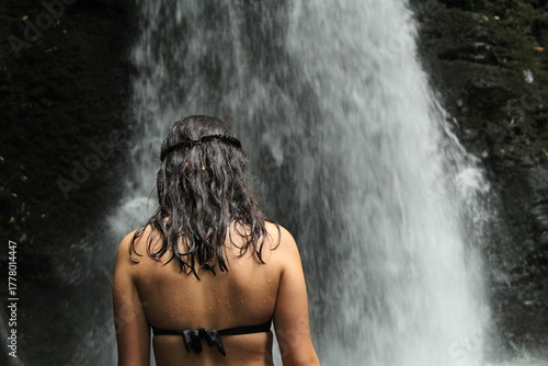 young woman in waterfall in azores island, portugal