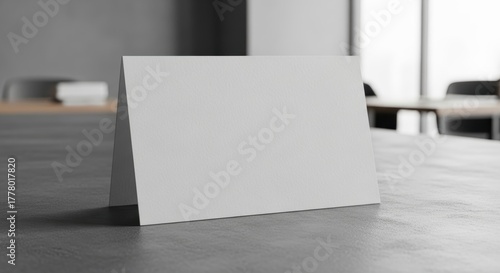 Blank tent card on modern office desk with blurred background